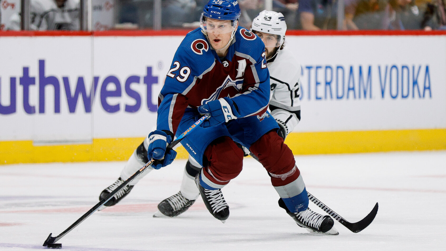 Blue-uniformed hockey player skating forward