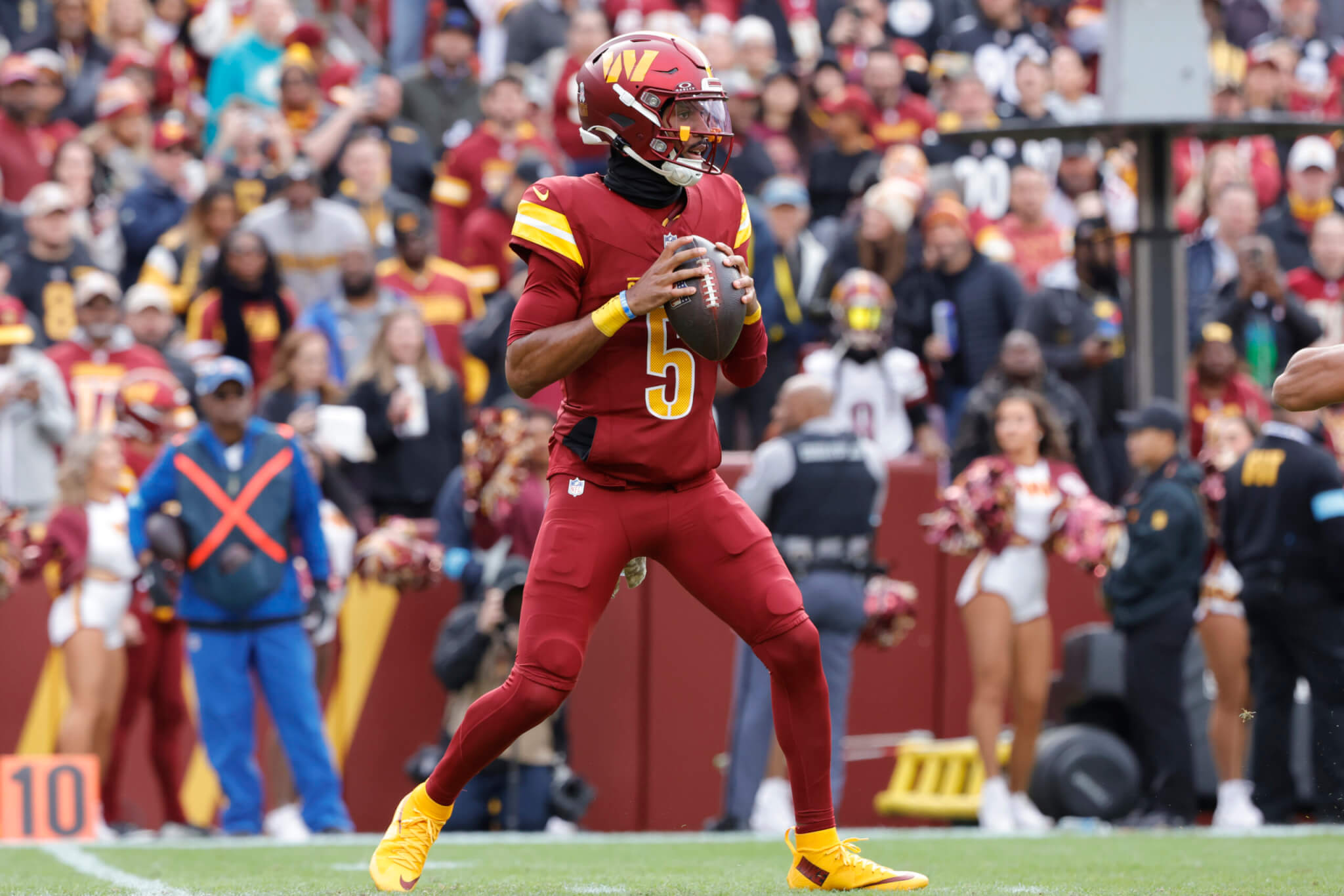 Football player throwing red ball