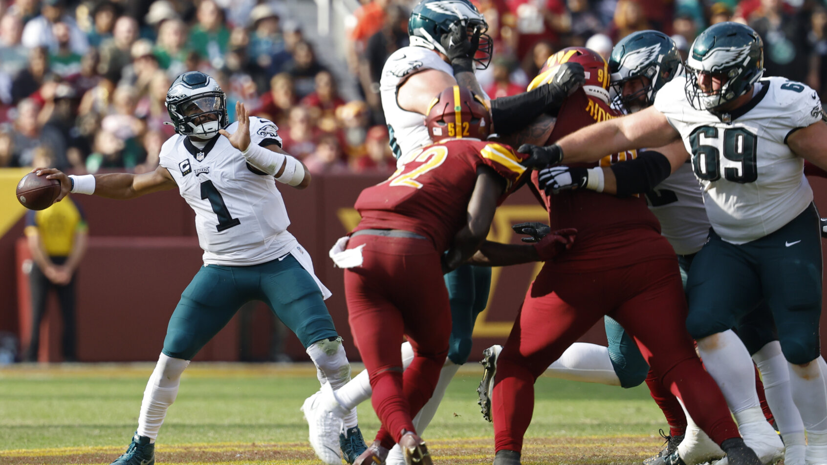 Football players colliding during tackle