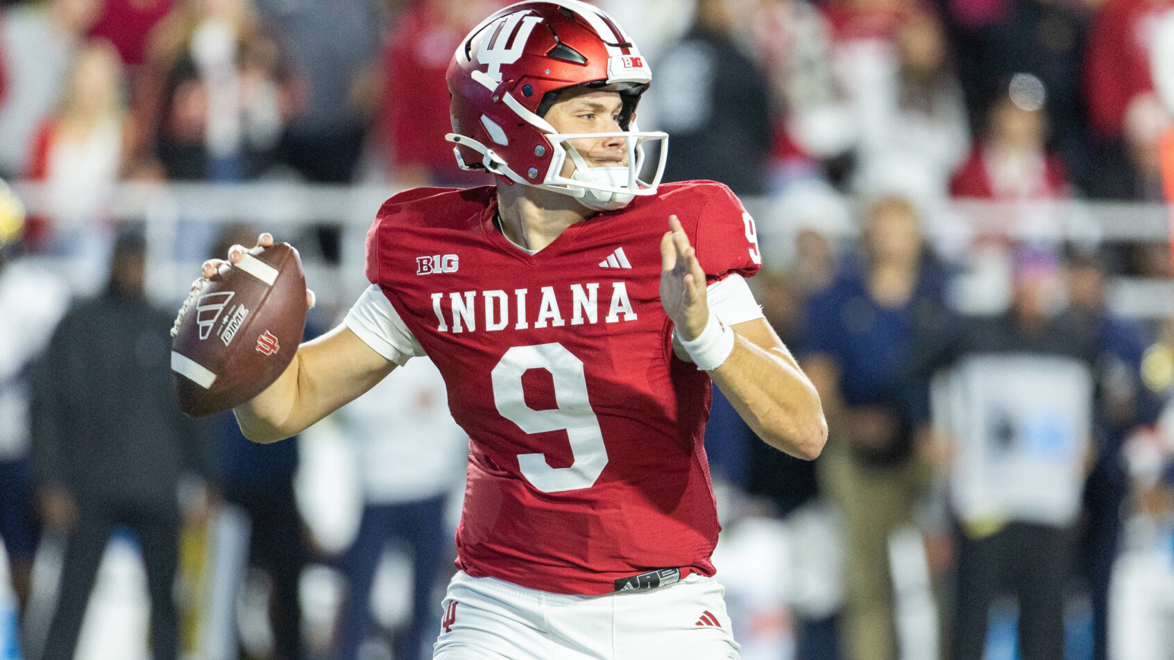 Indiana quarterback throws football pass