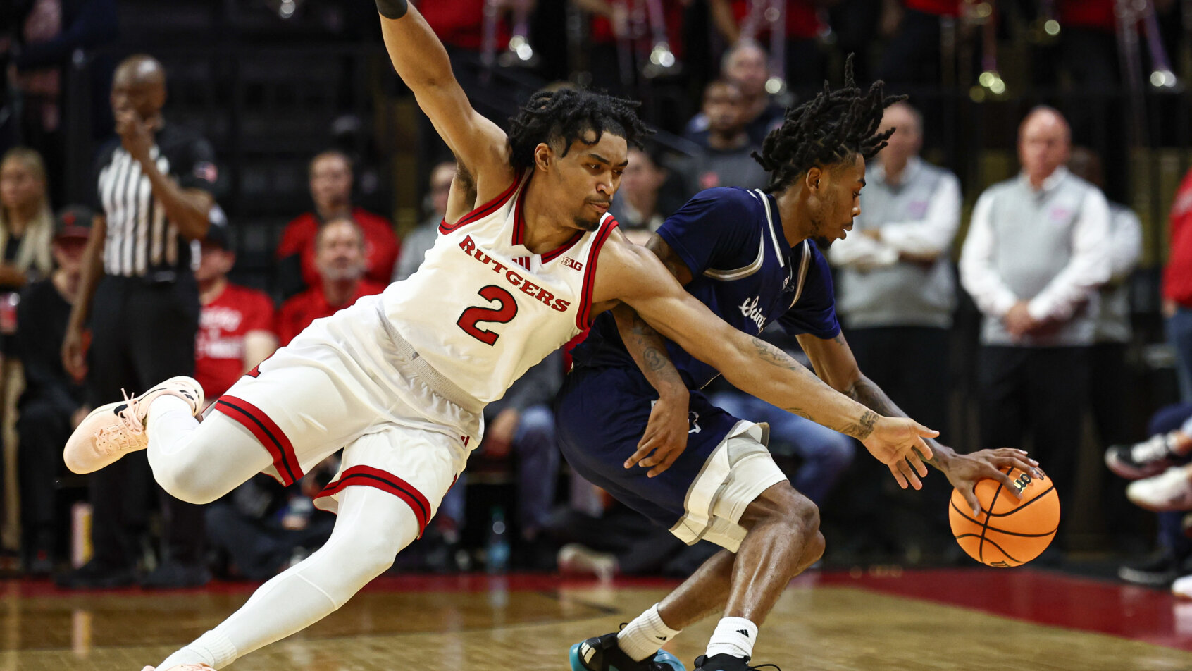 Two players defend on basketball court