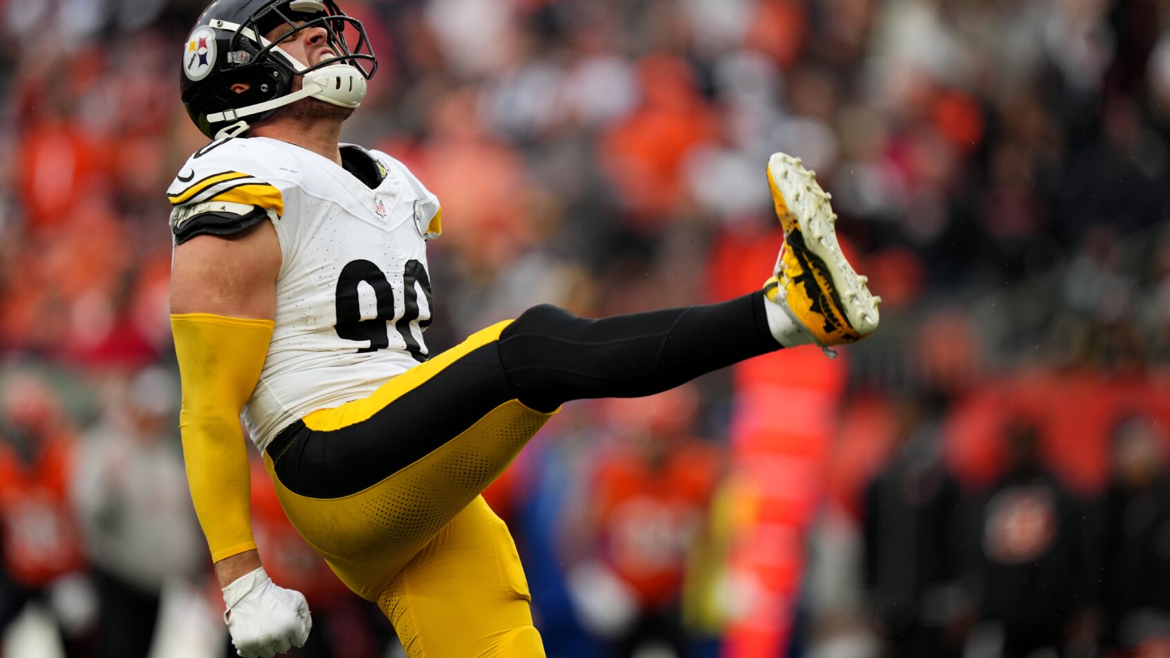 Football kicker strikes ball in motion