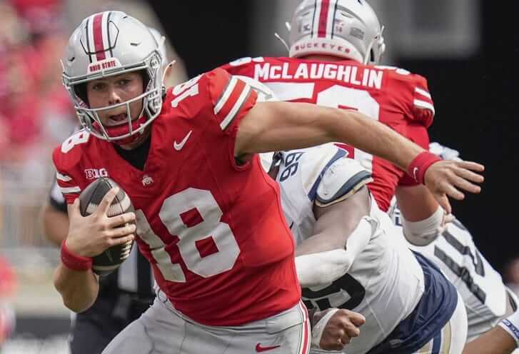 Buckeyes player carries football during play