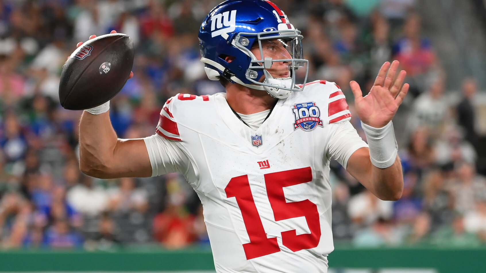 Football player throwing pass mid-game