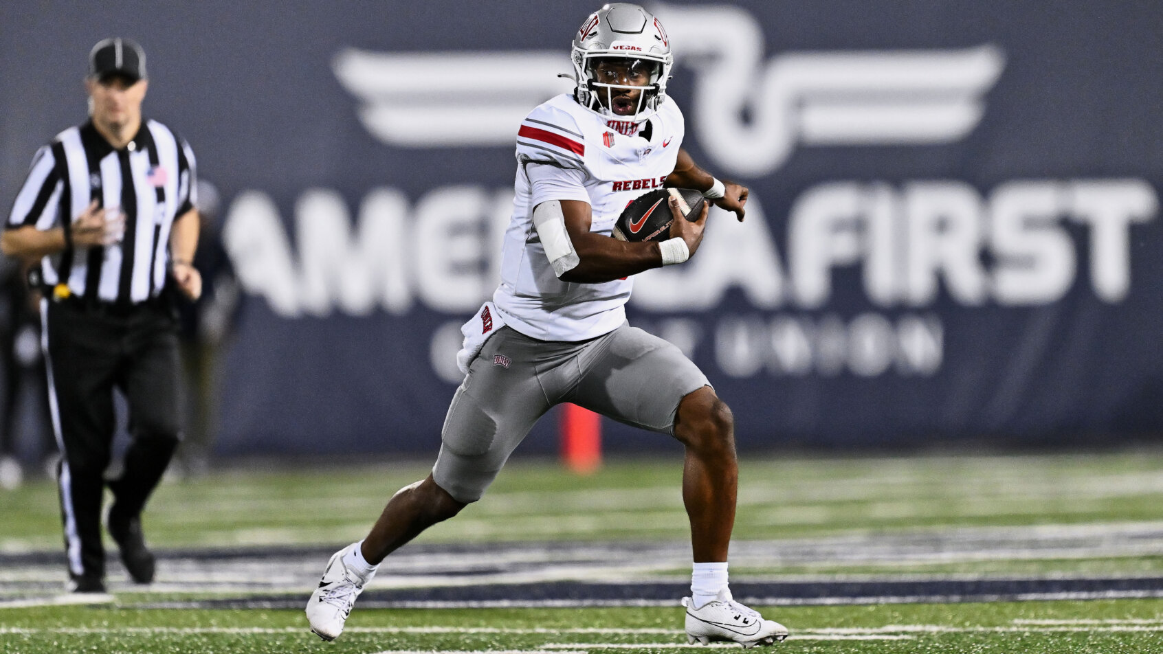 NFL player carries ball downfield