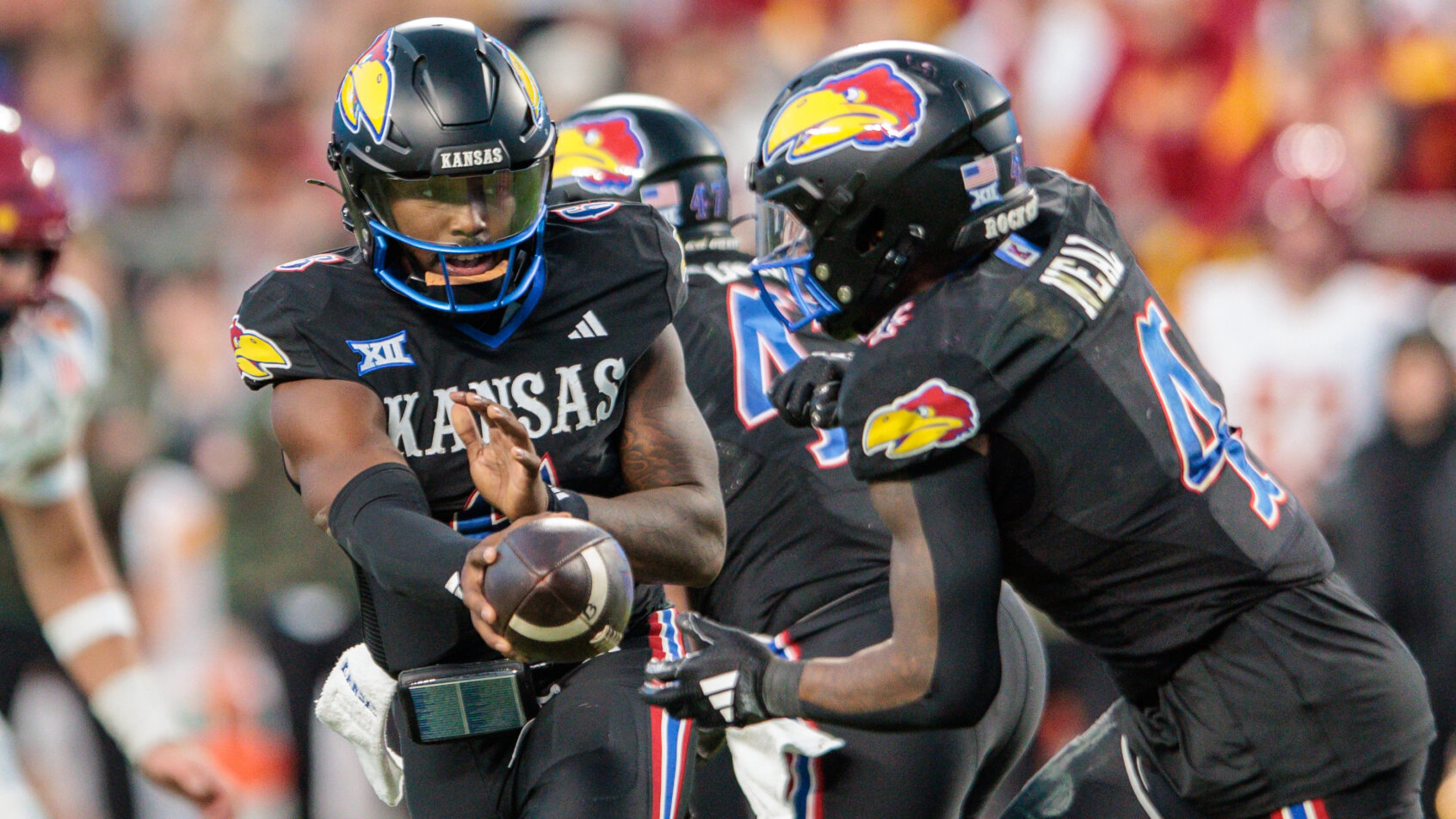 Kansas Jayhawks players celebrate football victory