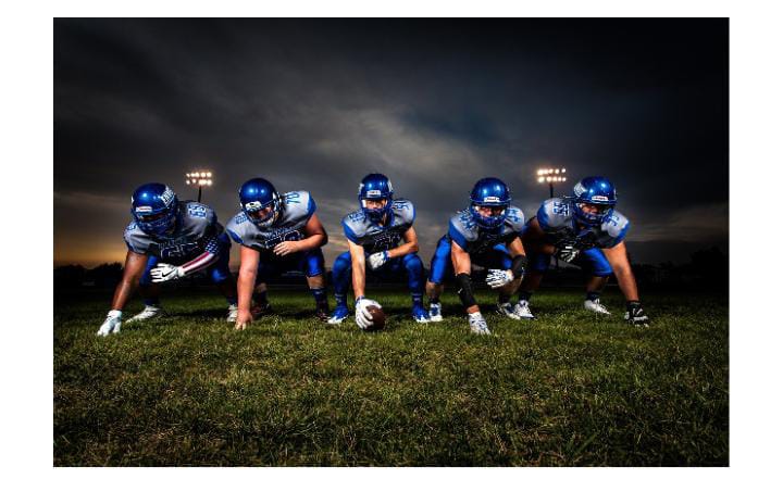 Blue-uniformed football players in action