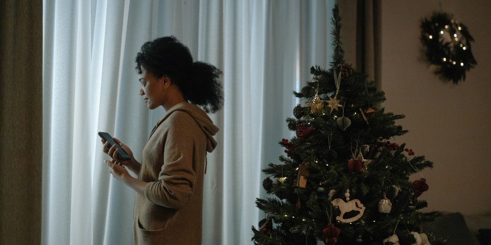 Woman near decorated holiday tree