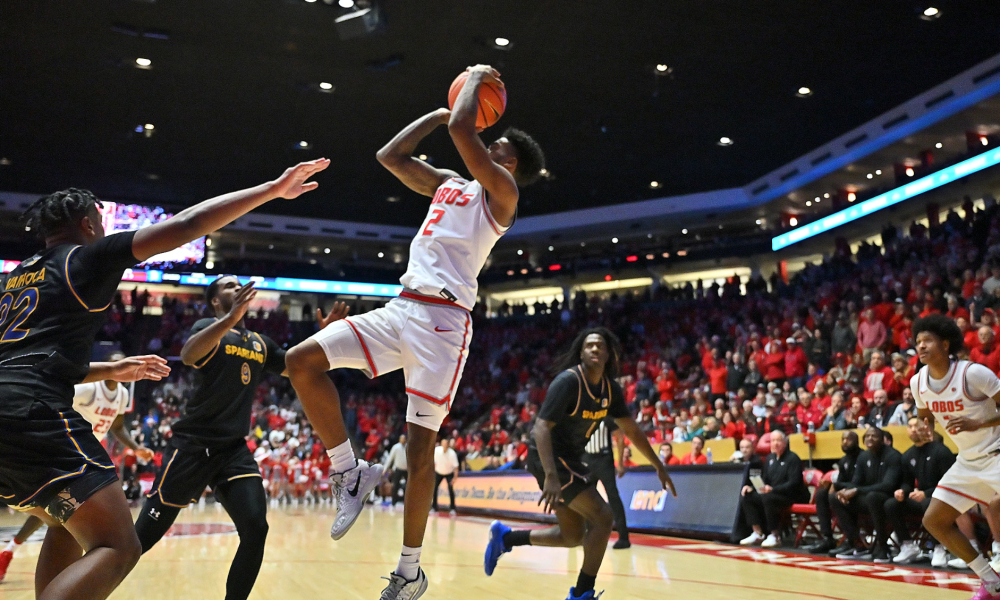 Player shooting basketball mid-jump