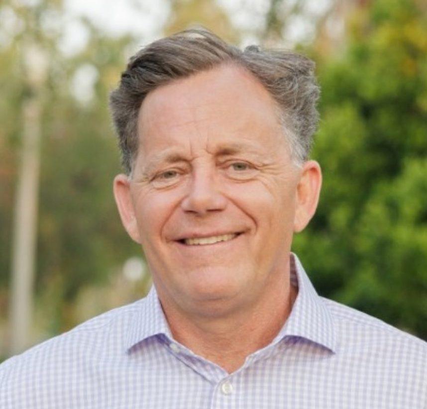 Smiling man against green backdrop