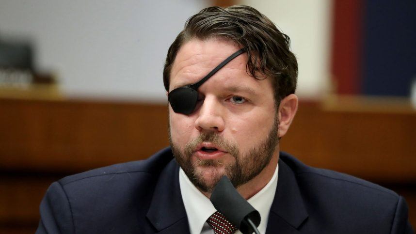 Man speaking at podium wearing suit