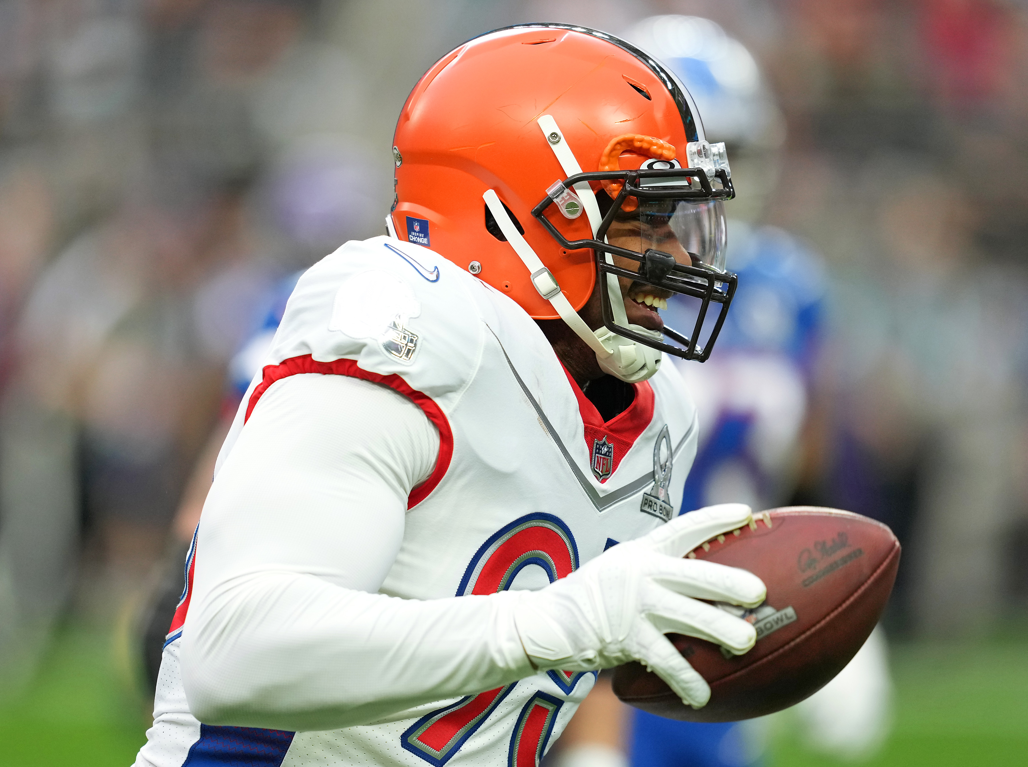 Orange-helmeted player in sporting gear