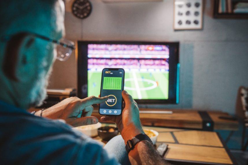 Man checks phone at sports bar