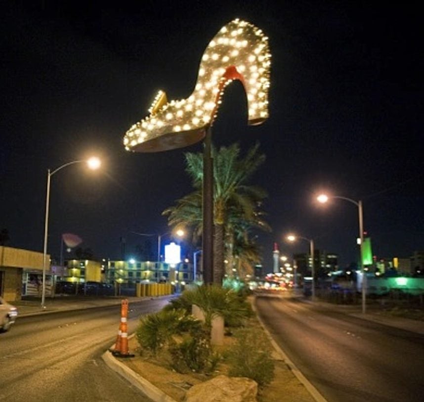 Illuminated neon shoe sign