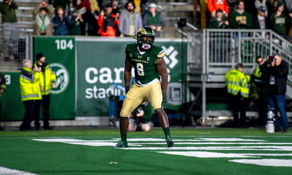 Football player sprints with ball