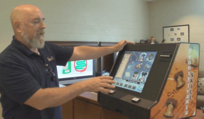 Bald man operating casino gaming terminal