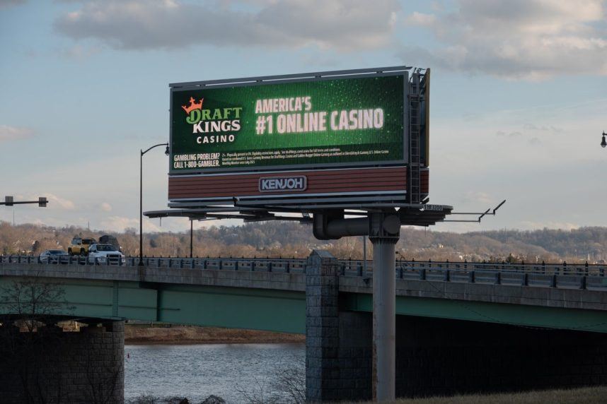 Kenjoh billboard above highway bridge