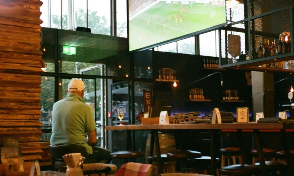 Man watches TV soccer match