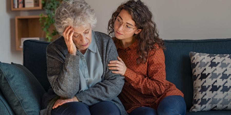 Woman comforting elderly mother