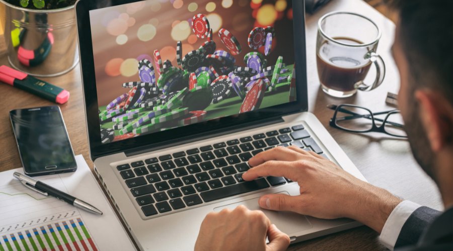 Man plays online poker on laptop