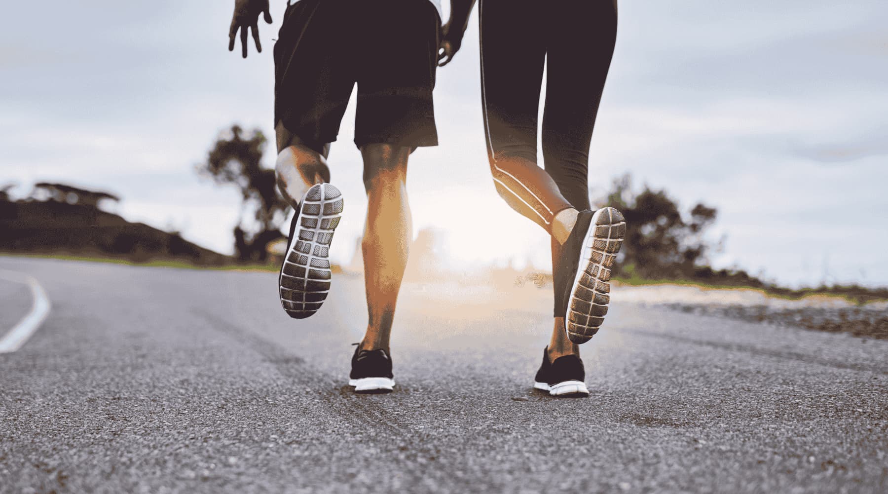 Two people jogging on pathway